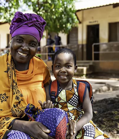 A mother and child outside a health centre in Africa