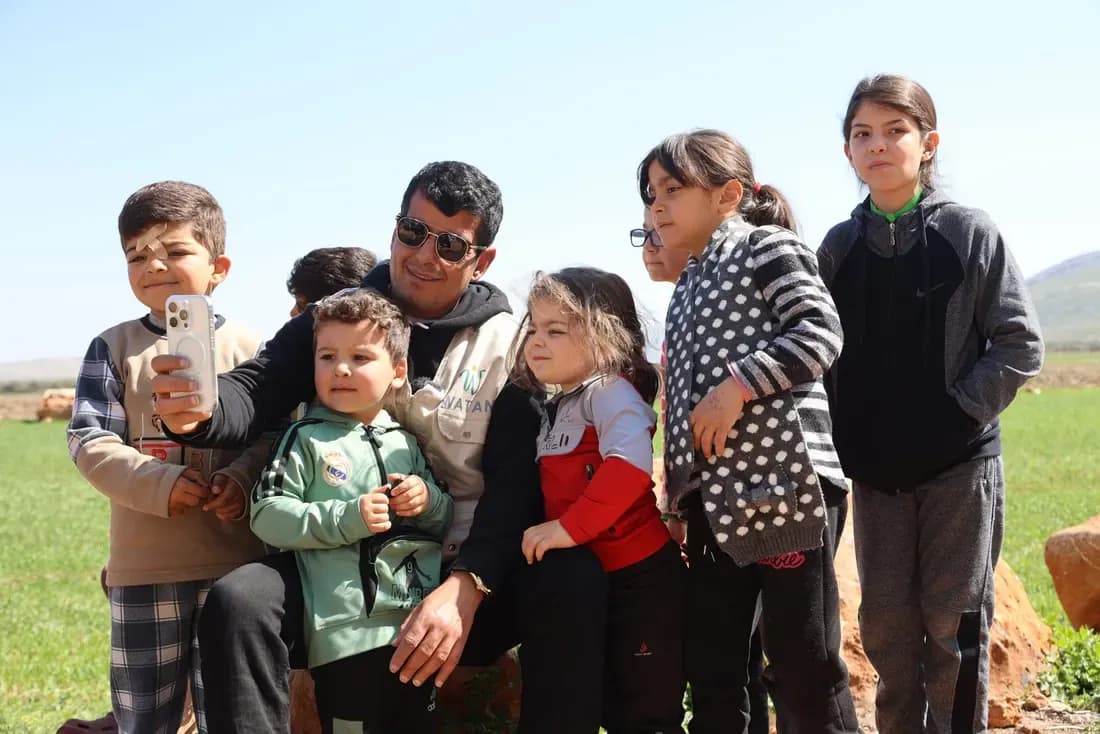 Watan USA team members with families they serve